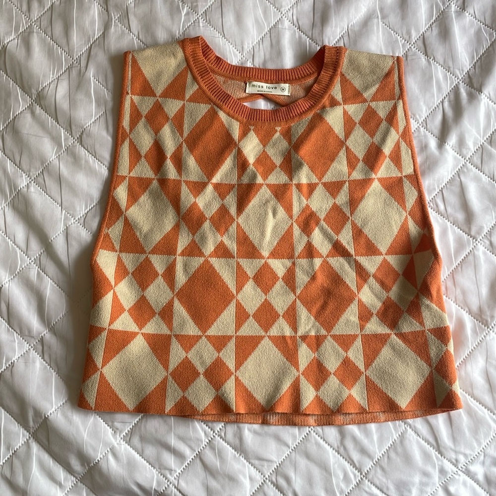 Size M orange and white checkered sweater vest open back.